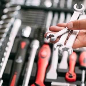 spanners-wrenches-tools-in-hands-repair-concepts-tools-box-min